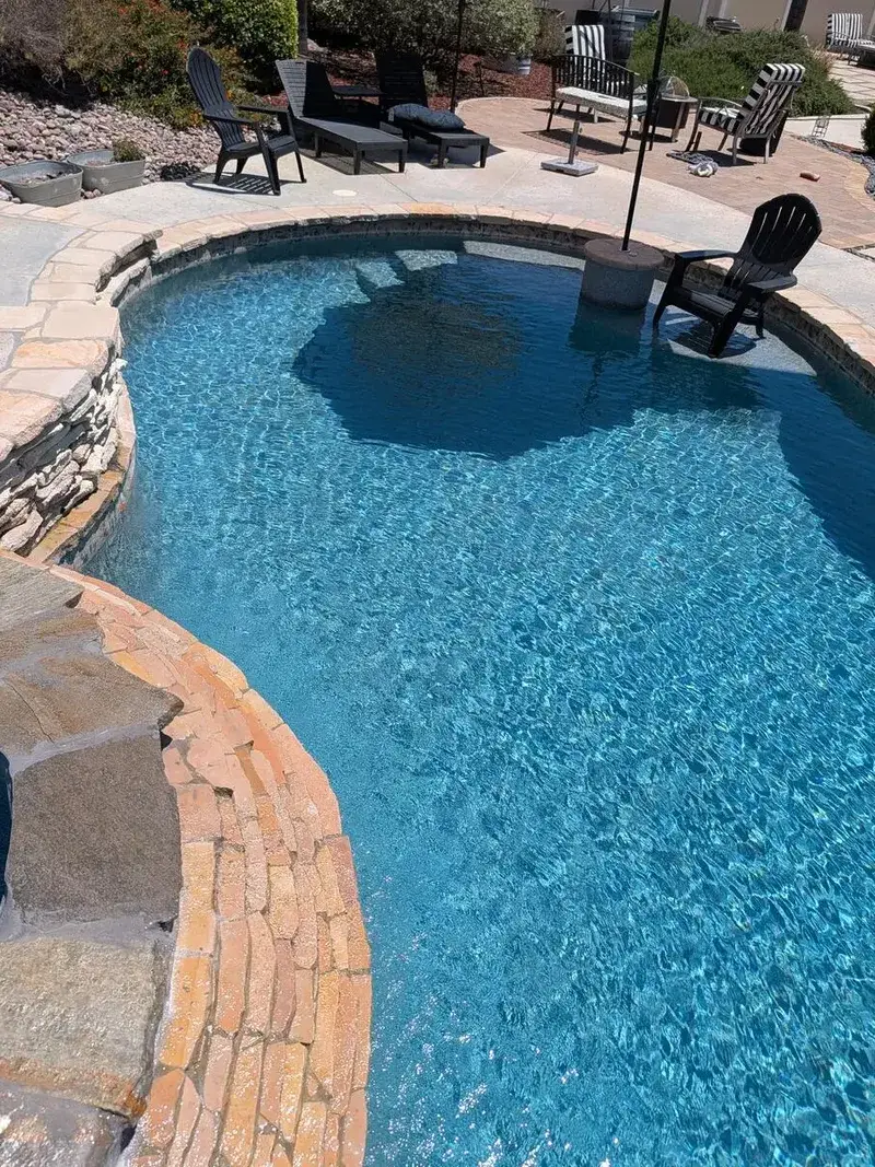 Completed Rivera Pools natural-stone coping work